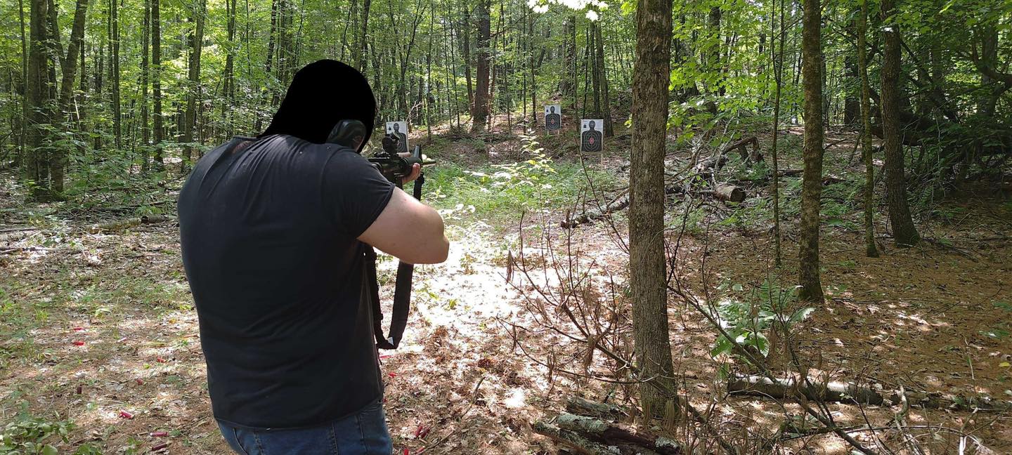 One of our members taking aim at a target down range in the woods.